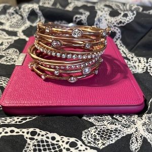 Stack of 10 rose gold colored bangles